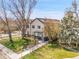 Charming two-story home featuring a well-manicured lawn and inviting front porch at 1303 Jersey St, Denver, CO 80220