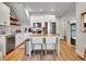Bright kitchen with stainless steel appliances, white cabinets, and a butcher block island at 1303 Jersey St, Denver, CO 80220