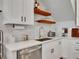 Modern kitchen with white countertops, stainless steel appliances, and sleek subway tile backsplash at 1303 Jersey St, Denver, CO 80220