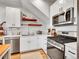 Modern kitchen with stainless steel appliances, white cabinets, and open shelving at 1303 Jersey St, Denver, CO 80220