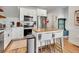 Modern kitchen boasts stainless steel appliances, white cabinets, and a butcher block island at 1303 Jersey St, Denver, CO 80220