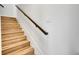 Bright staircase features wooden stairs and a black handrail at 1303 Jersey St, Denver, CO 80220