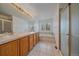 Large bathroom featuring a double vanity, soaking tub, and walk-in shower at 18168 E Caley Cir, Aurora, CO 80016