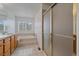 Bathroom featuring a double vanity, soaking tub with tile surround, and walk-in shower with glass door at 18168 E Caley Cir, Aurora, CO 80016