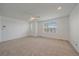Spacious bedroom features neutral carpet, ceiling fan, and large windows creating a sun-filled space at 18168 E Caley Cir, Aurora, CO 80016