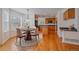 Sunny dining area with wood floors and adjacent kitchen at 18168 E Caley Cir, Aurora, CO 80016