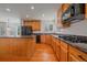 Kitchen featuring stainless steel appliances, wood cabinets and granite countertops at 18168 E Caley Cir, Aurora, CO 80016
