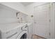 Laundry room with modern washer, dryer, and shelving at 18168 E Caley Cir, Aurora, CO 80016