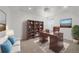 Inviting home office featuring a wooden desk and bookshelves at 18168 E Caley Cir, Aurora, CO 80016