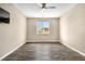 Bright and empty bedroom with vinyl plank flooring, a ceiling fan, and a large window at 847 E 98Th Ave # 1806, Thornton, CO 80229