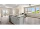 Modern kitchen open to living area features stainless steel appliances, granite counters, and balcony access at 847 E 98Th Ave # 1806, Thornton, CO 80229