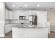 Well-lit kitchen boasts stainless steel appliances, granite countertops, and ample white cabinetry for storage at 847 E 98Th Ave # 1806, Thornton, CO 80229