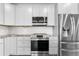 Modern kitchen design with stainless steel appliances, white cabinetry, and granite countertops offers sleek aesthetic at 847 E 98Th Ave # 1806, Thornton, CO 80229