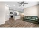 Inviting living area seamlessly connects to a modern kitchen, providing open-concept living space with wood floors at 847 E 98Th Ave # 1806, Thornton, CO 80229
