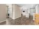 Open concept living space with luxury vinyl plank flooring, laundry and access to the kitchen at 847 E 98Th Ave # 1806, Thornton, CO 80229