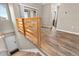 View of the staircase with wood railing and view to the front door and a sliding door to the patio at 847 E 98Th Ave # 1806, Thornton, CO 80229