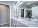 Bathroom with dual sinks, vanity, ample lighting and framed mirror over the countertop at 952 Morning Glory Rd, Brighton, CO 80640