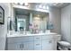 Well-lit bathroom with double sinks, white cabinetry, and modern fixtures at 952 Morning Glory Rd, Brighton, CO 80640