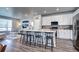 Bright open-concept kitchen with modern appliances, a large island, and seamless flow to the living space at 952 Morning Glory Rd, Brighton, CO 80640
