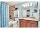 Bathroom featuring tile flooring, granite countertops, and a shower and tub combination at 12764 Ironstone Way # 103, Parker, CO 80134
