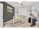 Bedroom features a ceiling fan, neutral carpet, and a painting above a sewing machine on a work desk at 12764 Ironstone Way # 103, Parker, CO 80134