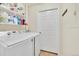 Laundry Room with shelving above a front-loading washing machine and dryer at 12764 Ironstone Way # 103, Parker, CO 80134