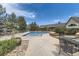Outdoor pool area with lounge chairs, landscaping, and a building in the background at 12764 Ironstone Way # 103, Parker, CO 80134