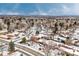 Wide aerial view of houses with city skyline in background at 1606 S Welch Cir, Lakewood, CO 80228