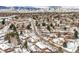Aerial view of neighborhood with snow-covered homes and mountains at 1606 S Welch Cir, Lakewood, CO 80228