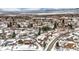 Aerial view of house and neighborhood in snowy landscape at 1606 S Welch Cir, Lakewood, CO 80228