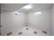 Finished basement room with neutral walls and tile floor at 1606 S Welch Cir, Lakewood, CO 80228