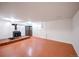 Finished basement room with wood-burning stove and built-in shelving at 1606 S Welch Cir, Lakewood, CO 80228