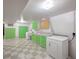 Laundry room with washer, dryer and green cabinets at 1606 S Welch Cir, Lakewood, CO 80228