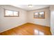 Bright bedroom featuring hardwood flooring and natural light from the double windows at 1606 S Welch Cir, Lakewood, CO 80228