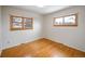 Serene bedroom with hardwood floors, two windows, and a peaceful ambiance for rest and relaxation at 1606 S Welch Cir, Lakewood, CO 80228