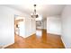 Bright dining room with hardwood floors and views to the kitchen and living area at 1606 S Welch Cir, Lakewood, CO 80228