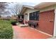 Inviting home entrance featuring a red brick facade and tidy landscaping at 1606 S Welch Cir, Lakewood, CO 80228