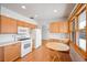 Eat-in kitchen featuring warm wood cabinetry and modern appliances at 1606 S Welch Cir, Lakewood, CO 80228