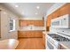 Kitchen with light wood cabinets and modern appliances at 1606 S Welch Cir, Lakewood, CO 80228