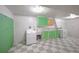 Basement laundry room with washer, dryer, utility sink, and checkered flooring at 1606 S Welch Cir, Lakewood, CO 80228