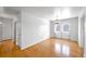 Spacious living room featuring hardwood floors and double doors to backyard at 1606 S Welch Cir, Lakewood, CO 80228