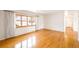 Bright living room with gleaming hardwood floors and large window at 1606 S Welch Cir, Lakewood, CO 80228