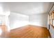 Bright and airy living room featuring gleaming hardwood floors and ample natural light from the windows at 1606 S Welch Cir, Lakewood, CO 80228