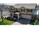 Spacious two-story home with a well-manicured lawn, brick accents, and a two-car garage at 23426 E Ottawa Dr, Aurora, CO 80016