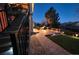 Inviting backyard patio with a stone fire pit and manicured landscaping, great for outdoor entertaining at 23426 E Ottawa Dr, Aurora, CO 80016