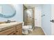 Modern bathroom with a walk-in shower, tile flooring, and neutral color palette at 23426 E Ottawa Dr, Aurora, CO 80016