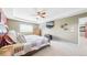 Bright bedroom with neutral walls, large window, and a cozy quilt on the bed at 23426 E Ottawa Dr, Aurora, CO 80016
