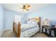 Light and airy bedroom featuring blue walls, a wooden bed frame, and natural light at 23426 E Ottawa Dr, Aurora, CO 80016