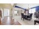 Elegant dining room featuring hardwood floors, a chandelier, and a blue accent wall and room with white built in shelves at 23426 E Ottawa Dr, Aurora, CO 80016