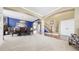Open-concept space with a dining area, staircase, and large windows at 23426 E Ottawa Dr, Aurora, CO 80016
